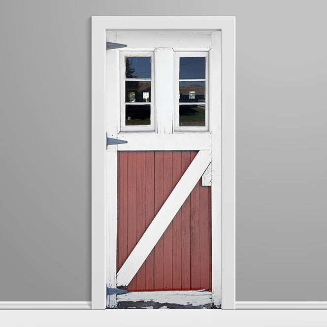 Red barn door with white frame on a gray background