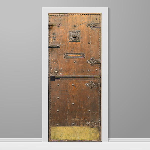 Decorative door with intricate designs on a gray wall