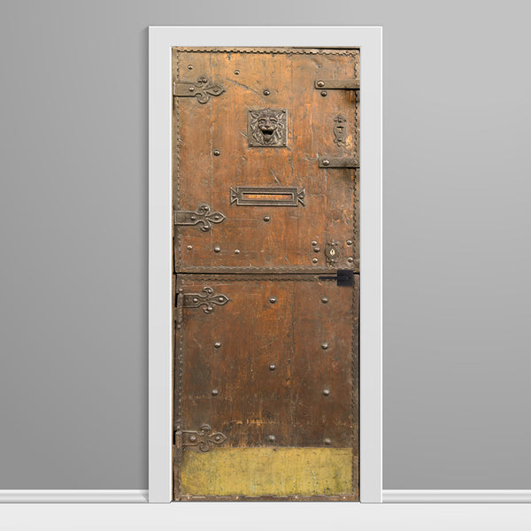 Decorative door with intricate designs on a gray wall