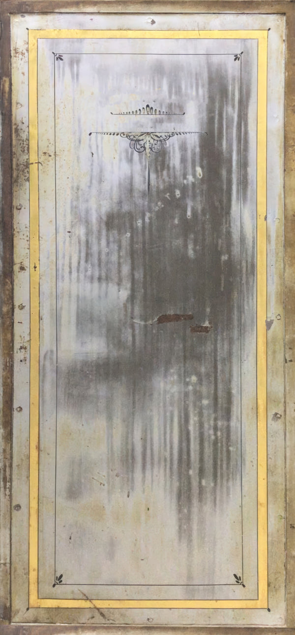 Metallic surface with a gold frame and decorative elements on a wooden background