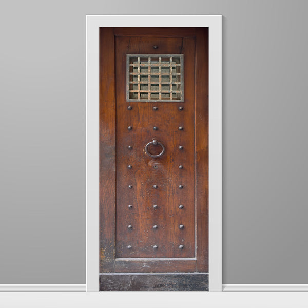 Wooden door with metal handle and glass panel on a gray wall