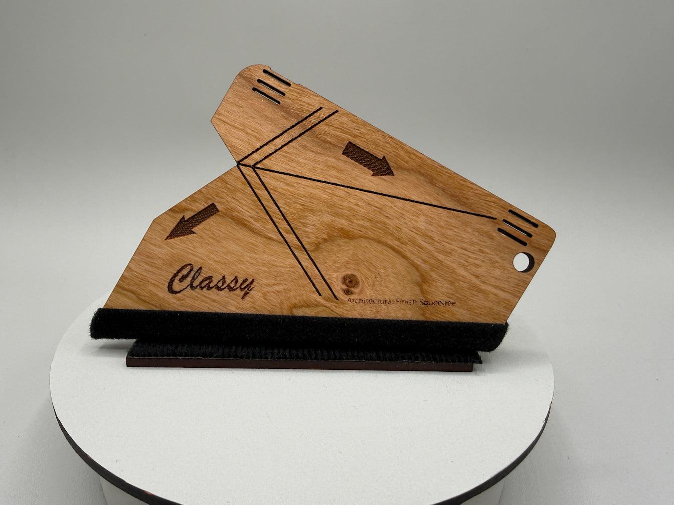 Wooden tool with 'Classy' branding on a white platform against a gray background