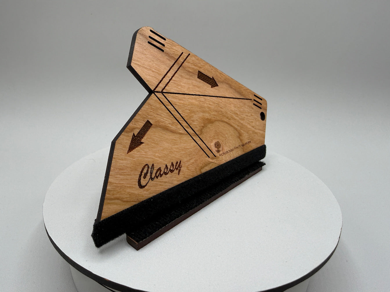 Wooden product with 'Classy' branding on a white stand against a gray background