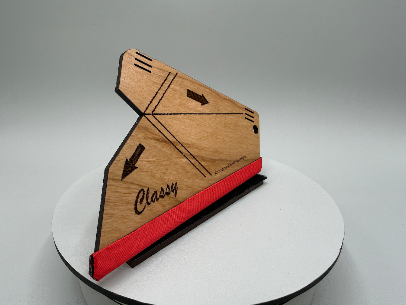 Wooden phone case with red accent and 'Classy' branding on a white platform.