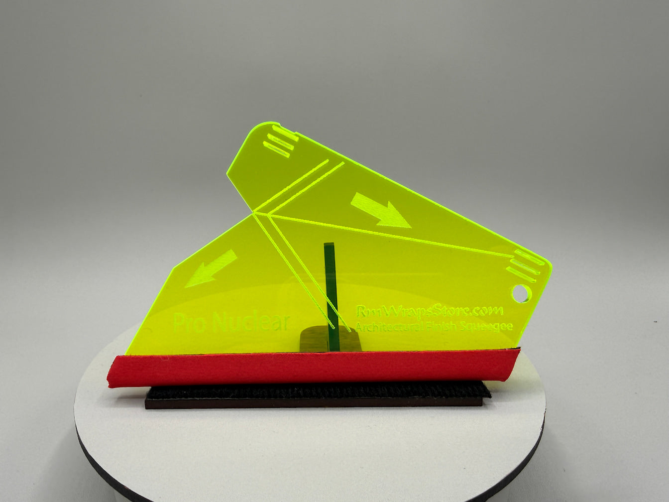 Yellow and red plastic tool on a gray background