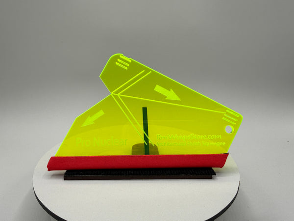 Yellow and red plastic tool on a gray background