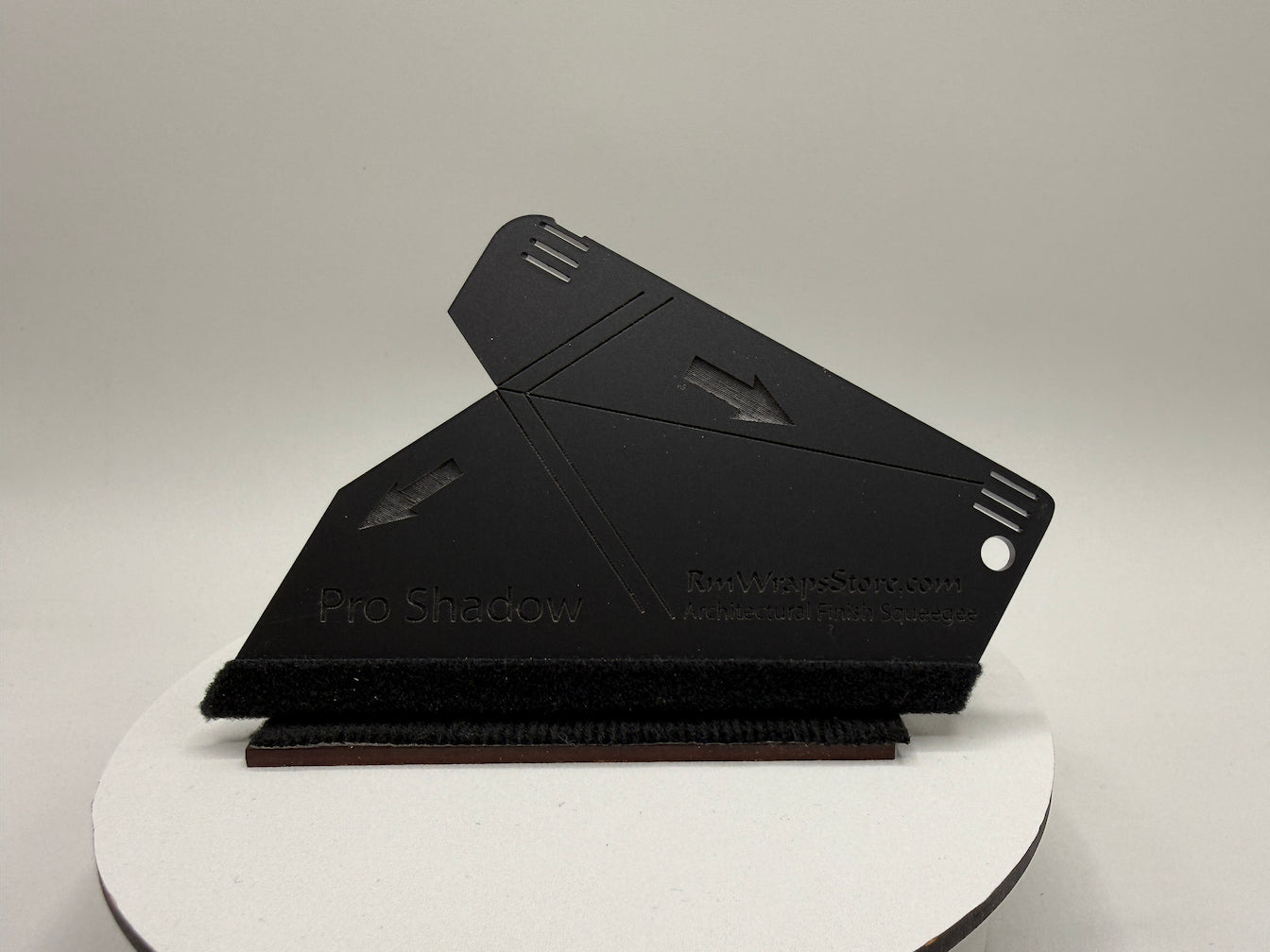 Black shadow box on a white platform with a gray background