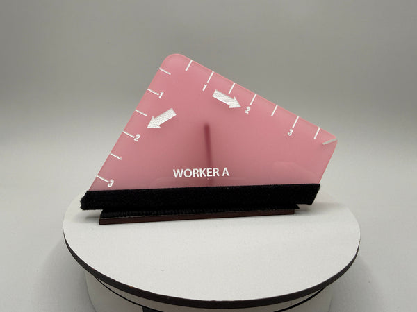 Pink and black object with 'WORKER A' text on a gray background