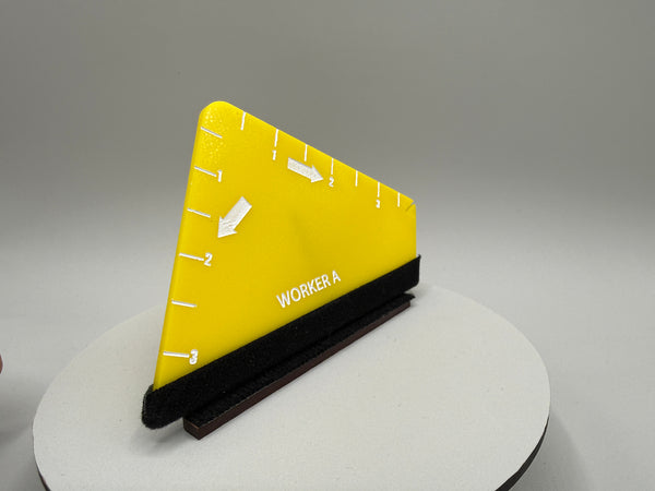 Yellow triangular ruler with black base on a gray background