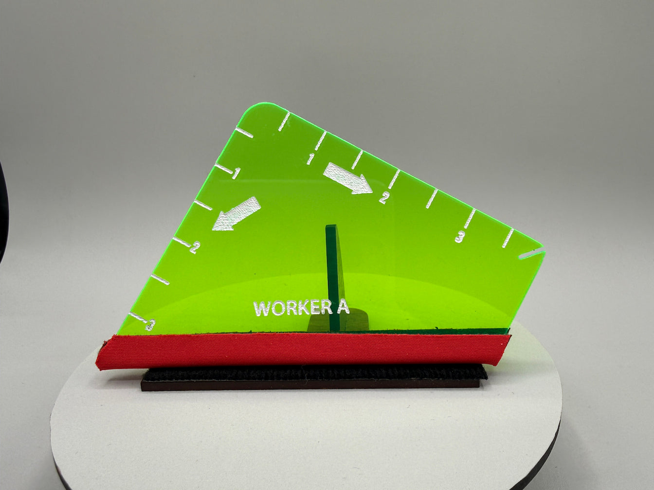 Green and red tool with 'WORKER A' label on a gray background