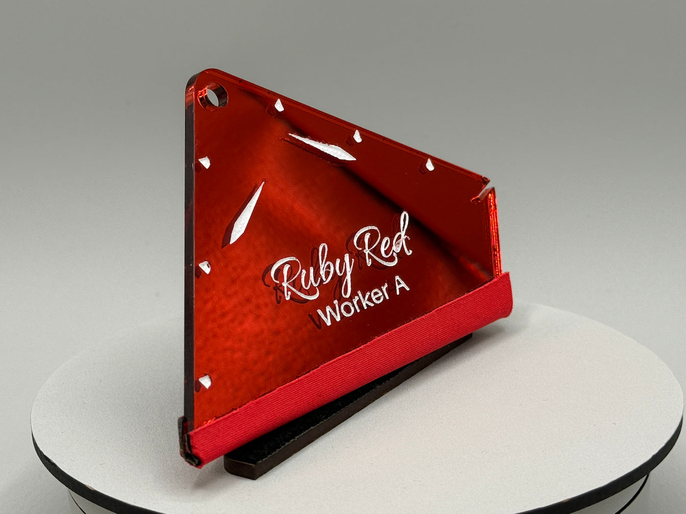 Red triangular sign with 'Ruby Red Worker A' text on a gray background