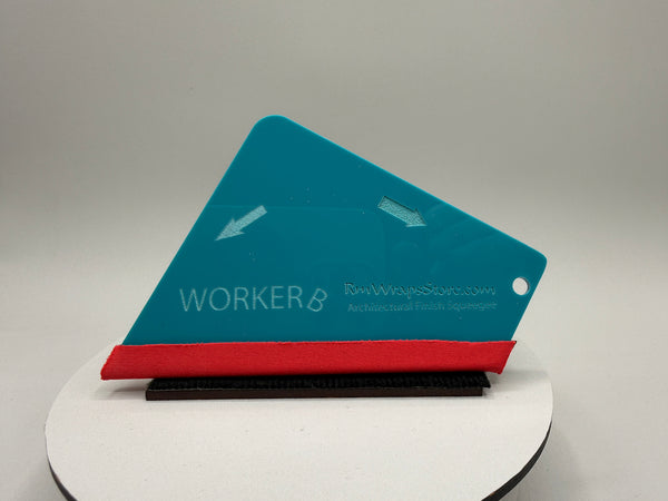 Blue and red squeegee on a white platform with a gray background