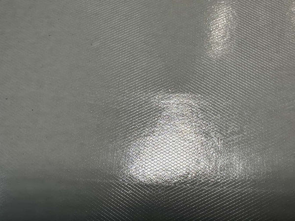 Close-up of textured gray surface with light reflection