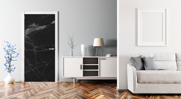 Modern living room with a black marble print on the wall, white cabinet, and gray sofa.