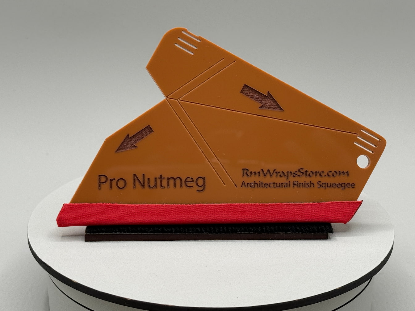 Pro Nutmeg architectural finish squeegee on a white stand with a gray background