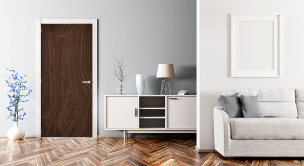 Modern living room with a wooden door, white cabinet, and gray sofa.