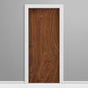 Wooden door with white frame on a gray background