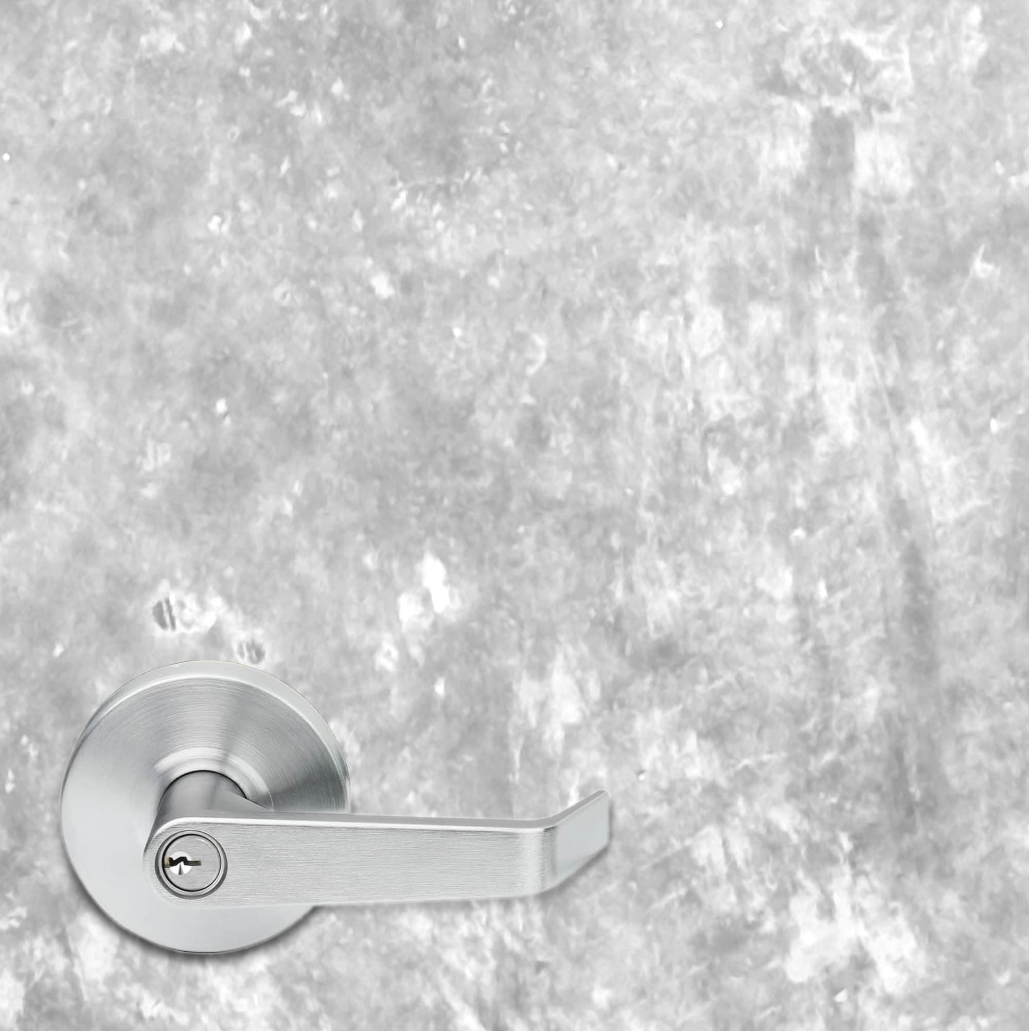 Silver door handle on a textured gray wall