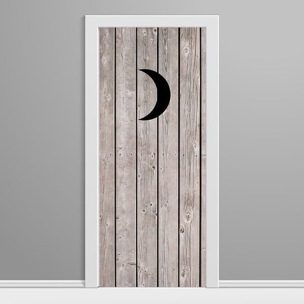 Wooden door with a black crescent moon design on a gray background