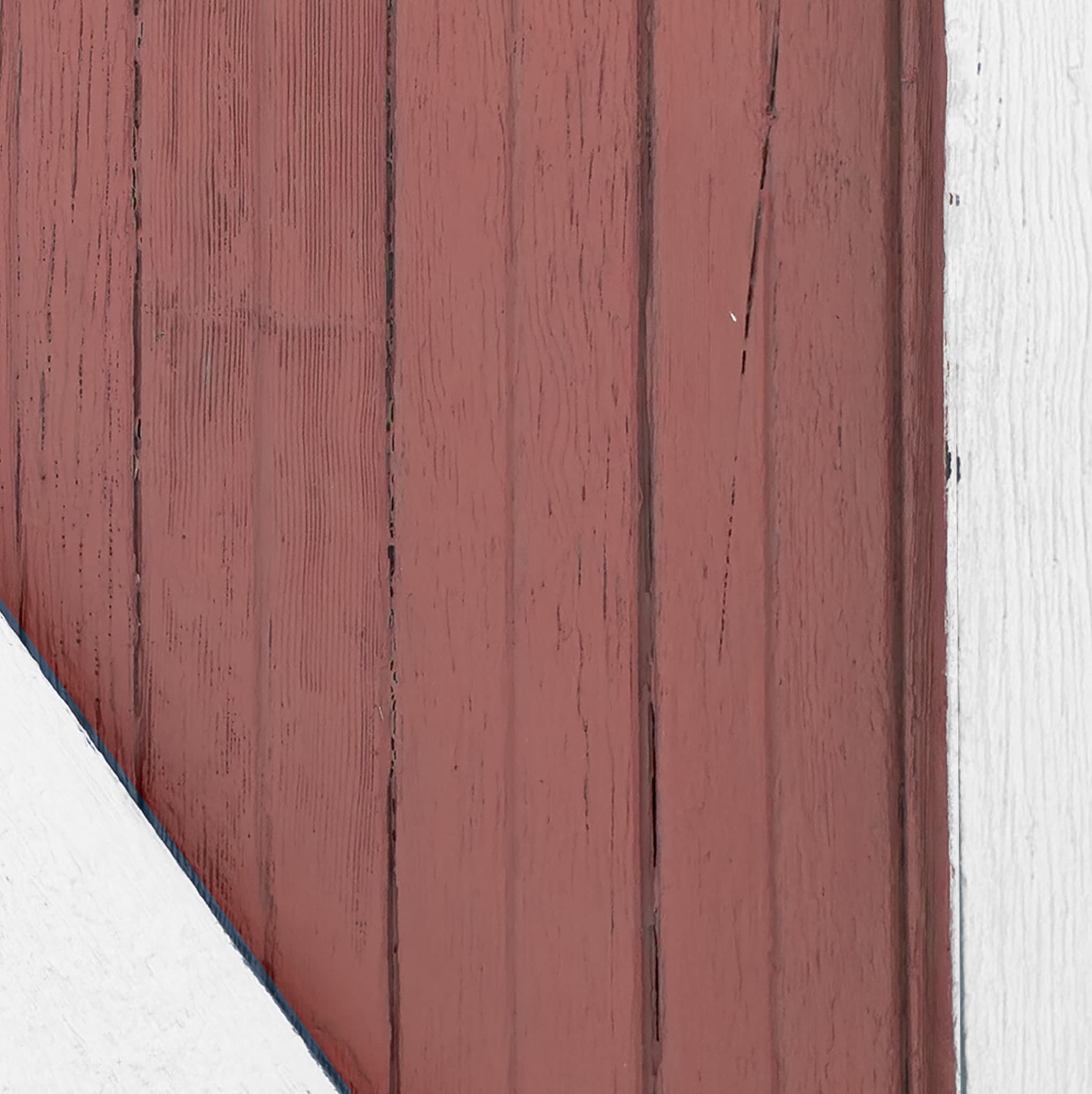 Close-up of a wooden panel with a reddish-brown color on a white background